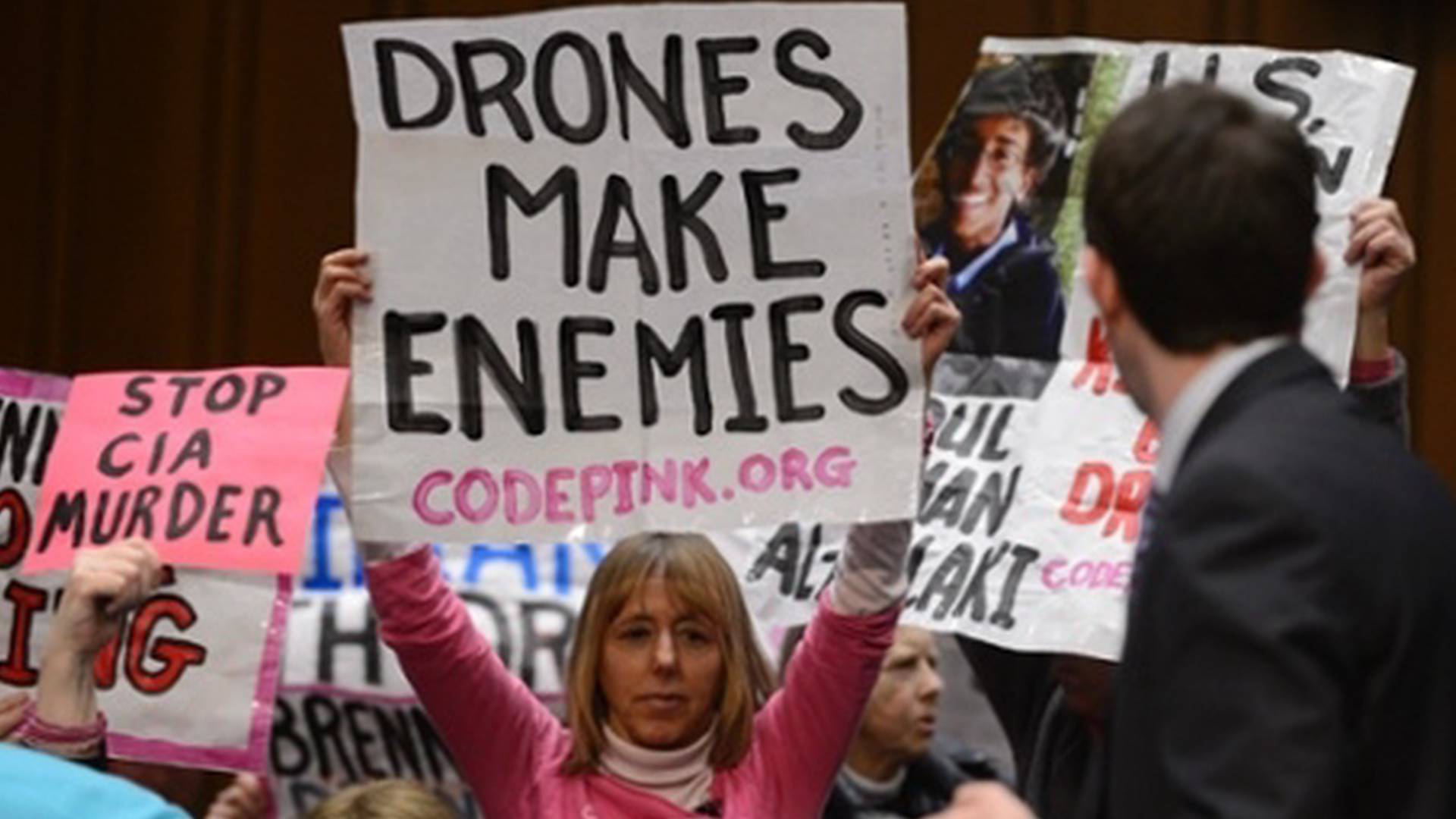 A group of people holding signs
Description automatically generated with medium confidence