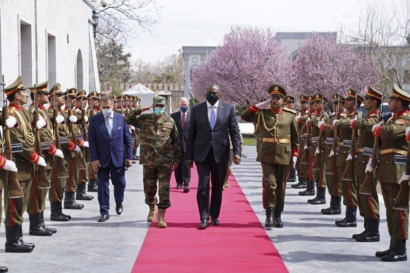 A group of people in military uniforms walking on a red carpet

Description automatically generated with medium confidence