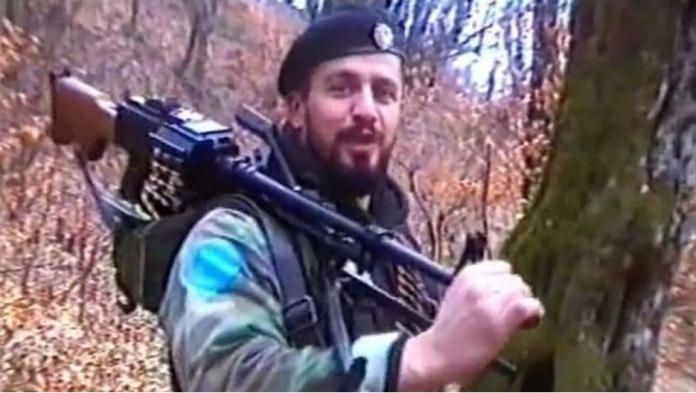 A person holding a gun

Description automatically generated with medium confidence