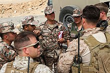 A picture containing military uniform, person, people, group
Description automatically generated