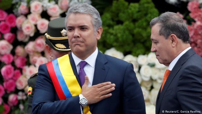 Colombia's new President Ivan Duque salutes to the audience after receiving the presidential sash from President of the Senate Ernesto Macias, during his inauguration ceremony at the Bolivar Square, in Bogota