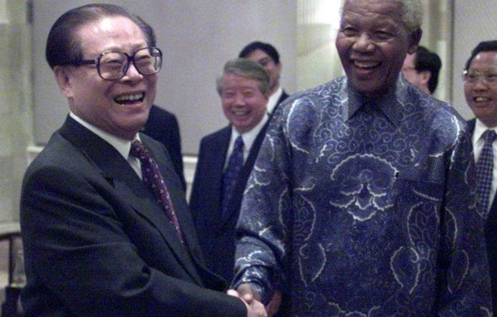 Former Chinese President Jiang Zemin greets former South African President Nelson Mandela in 2000.