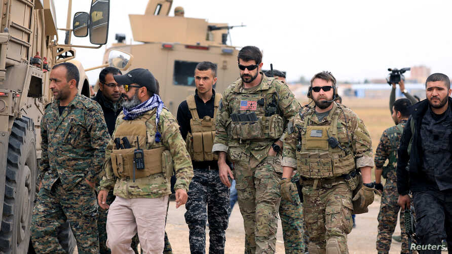 Syrian Democratic Forces and U.S. troops are seen during a patrol near Turkish border in Hasakah, Syria, Nov. 4, 2018.