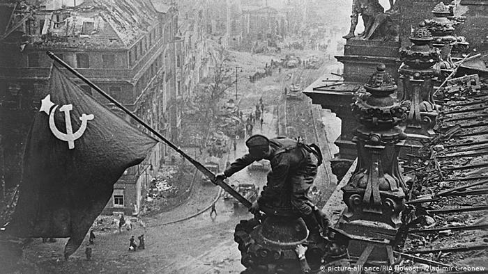 The Soviet flag being raised above the Reichstag