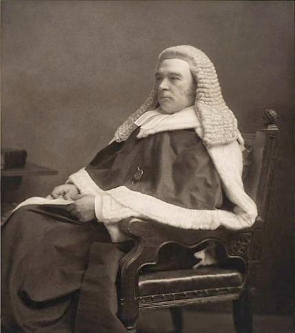 A statue of a person sitting in a chair
Description automatically generated with medium confidence
