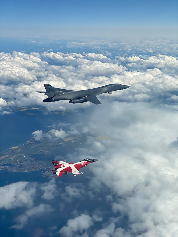 A B-1B Lancer flies with a Danish F-16 during a training mission for Bomber Task Force Europe, May 5, 2020. Aircrews from the 28th Bomb Wing at Ellsworth Air Force Base, South Dakota, took off on their long-range, long-duration Bomber Task Force mission to conduct interoperability training with Danish fighter aircraft and Estonian joint terminal attack controllers ground teams. Training with our NATO allies and theater partner nations contribute to enhanced resiliency and interoperability and enables us to build enduring relationships necessary to confront the broad range of global challenges. (Courtesy photo by Danish Air Force)
