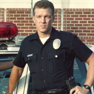 A person in a police uniform

Description automatically generated with medium confidence