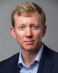 A person in a suit
Description automatically generated with medium confidence