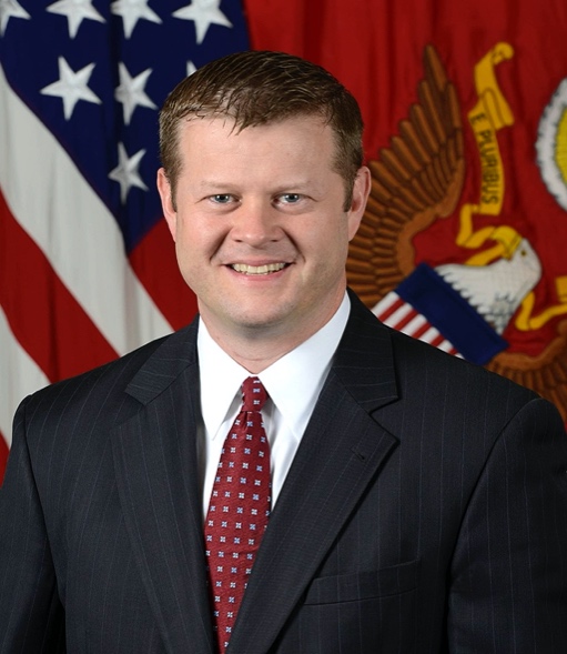 A person in a suit smiling

Description automatically generated with low confidence