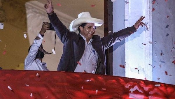Pedro Castillo greets from the balcony of his party's headquarters, Lima, Peru, June 15, 2021.