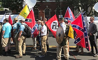 A group of people holding flags

Description automatically generated with medium confidence
