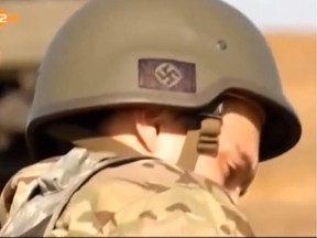 A news broadcast by German ZDF station on September 8 showed soldiers of the Ukraine Azov Battalion in Mariupol with nazi symbols on their helmets0922 weapons