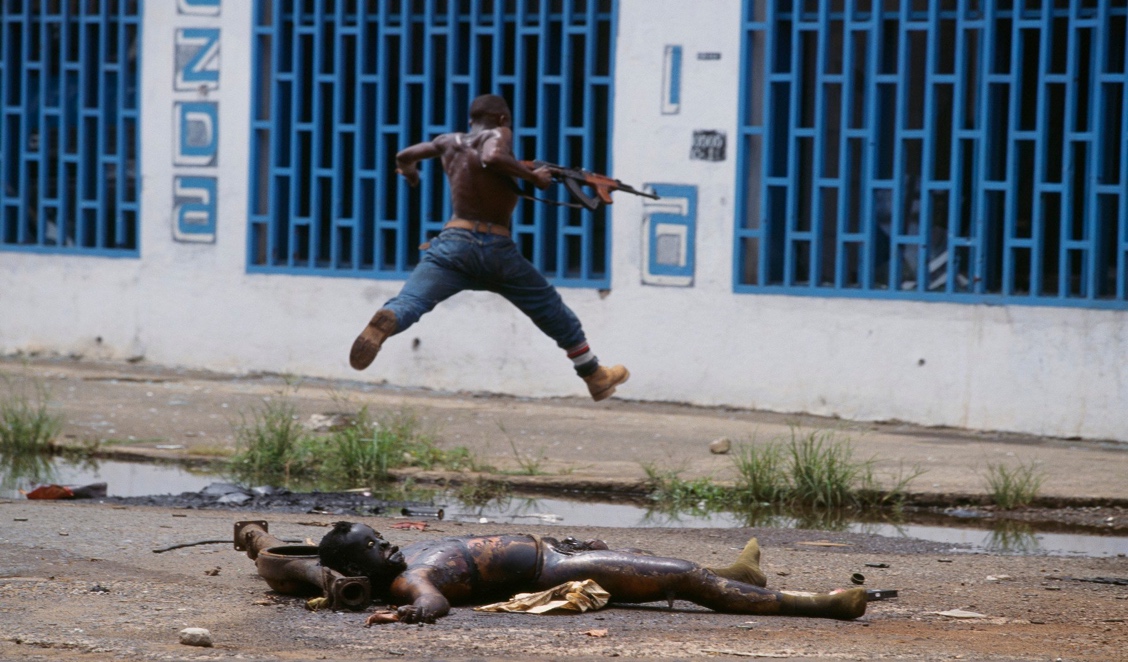 A person jumping over dead animals
Description automatically generated with low confidence