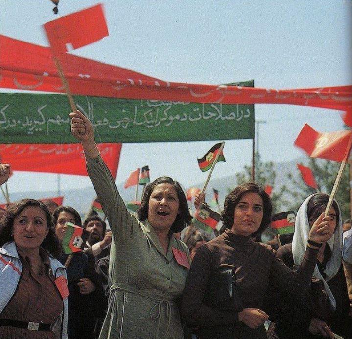 A group of people holding a flag

Description automatically generated with low confidence