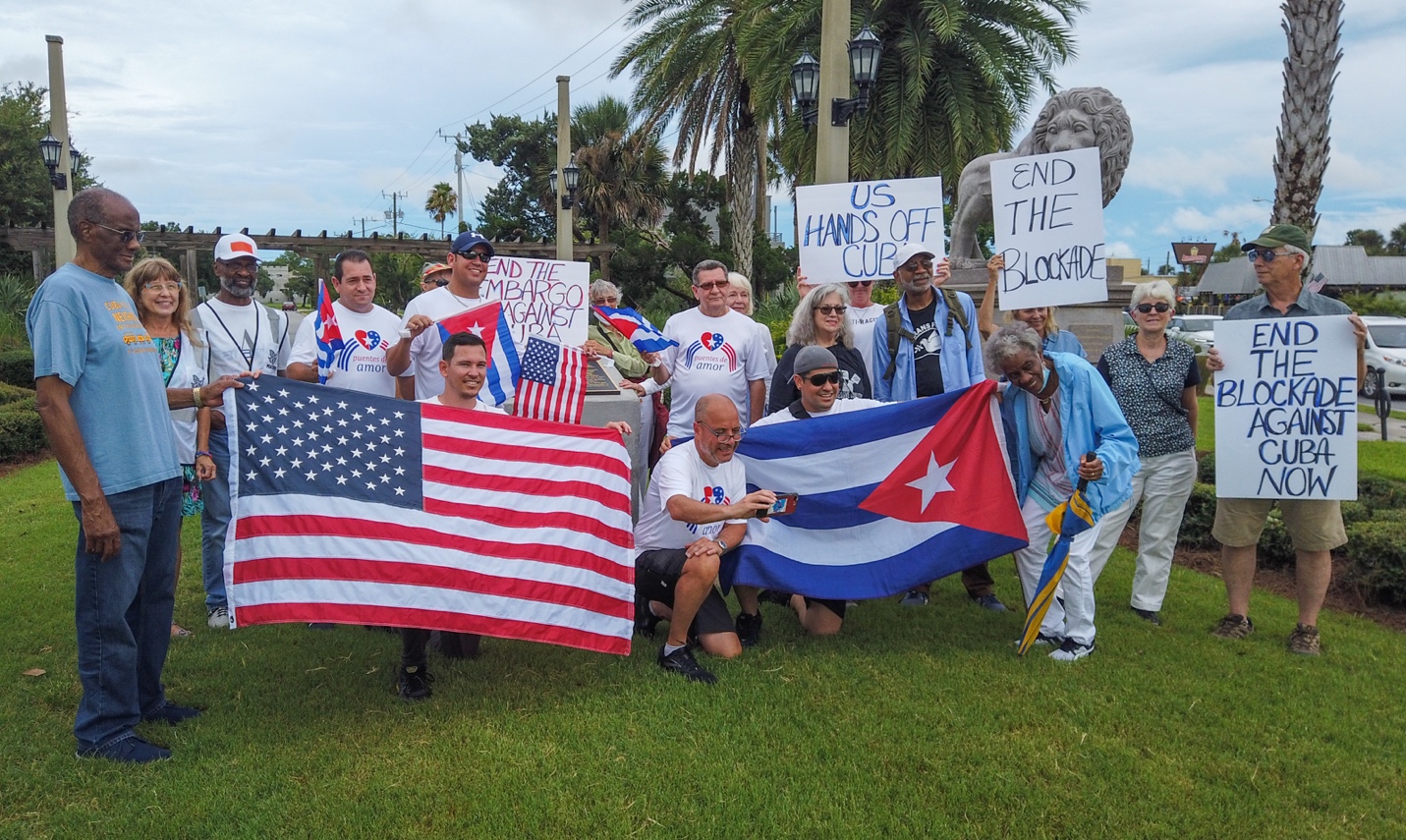 A group of people holding a flag

Description automatically generated with medium confidence