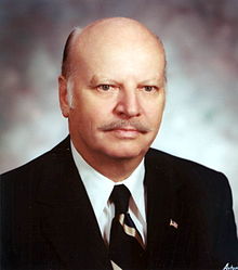 A person in a suit and tie

Description automatically generated with medium confidence