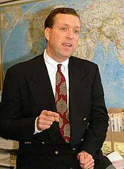 A person in a suit and tie

Description automatically generated with medium confidence