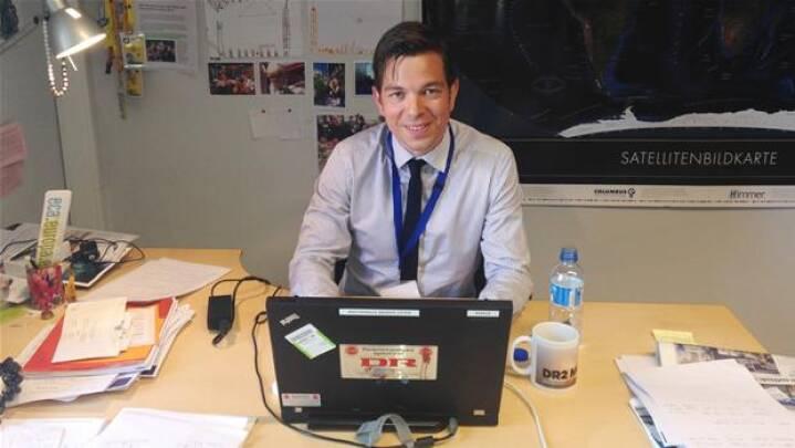 A person sitting at a desk

Description automatically generated with medium confidence