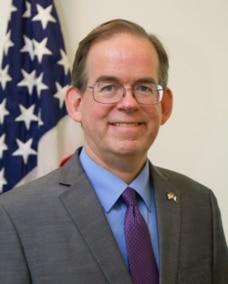 A person wearing glasses and a suit

Description automatically generated with medium confidence