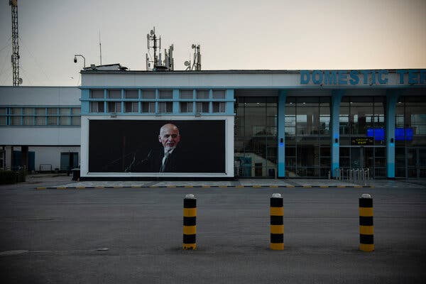 A poster of Ashraf Ghani outside the deserted domestic terminal at the airport in Kabul on Sunday morning.