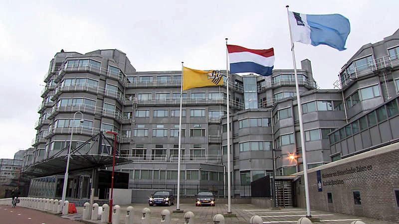 A few flags flying in front of a building

Description automatically generated with low confidence