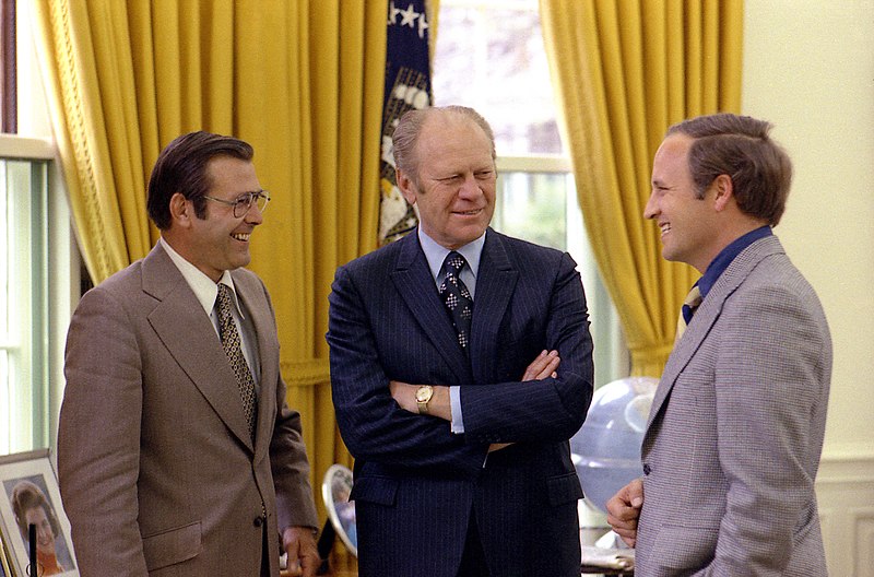 A few men talking to each other

Description automatically generated with low confidence