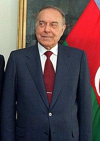A person in a suit and tie

Description automatically generated with medium confidence