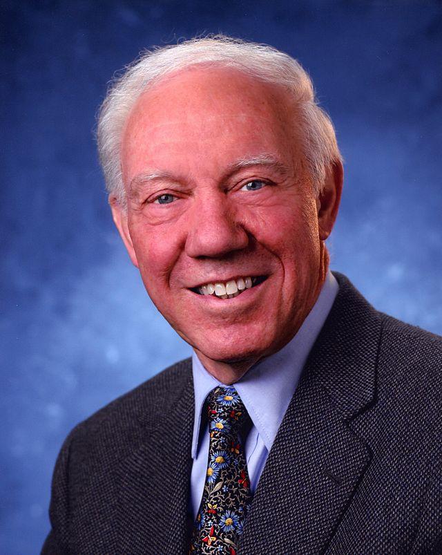 A person in a suit smiling

Description automatically generated with medium confidence
