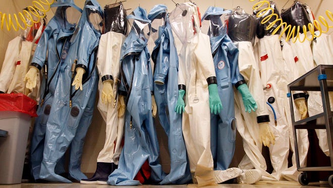 Biohazard suits hang inside a biosafety level 4 laboratory suite at the U.S. Army Medical Research Institute of Infectious Diseases in Fort Detrick, Md., in 2011. The BSL-4 lab, which is the the highest security-level lab possible, is used for handling deadly pathogens that have no vaccine or cure.