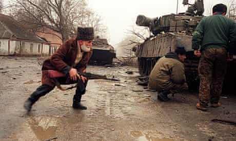 Chechen rebels take cover behind a tank during street fighting in Grozny in 1995. 