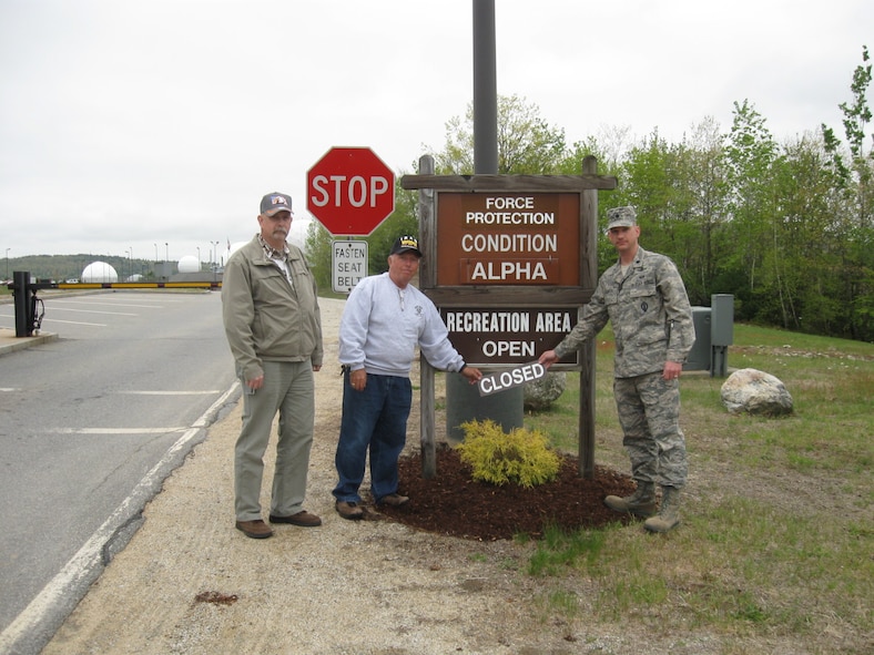 Dick Gamache and Herb Dixon, Department of Defense cardholders, stands with Lt. Col. David Hanson, 23rd Space Operations Squadron commander, after officially reopening the recreation area on New Boston Air Force Station. The area was previously closed due to an Air Force unexploded ordnance remediation project. (Courtesy photo)