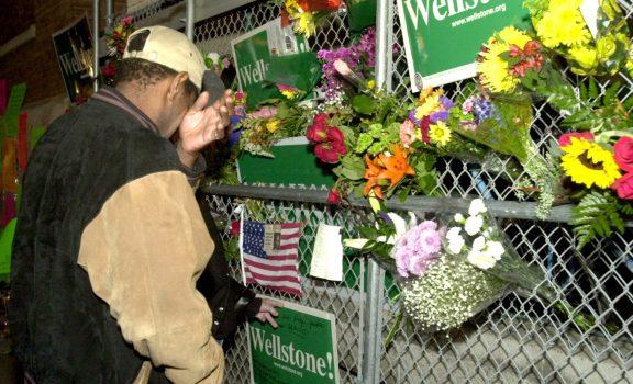 "It is heartbreaking," said Garye Martin of St. Paul, who brought flowers to place on the fence outside of Paul Wellstone's University Avenue headquarters. (Pioneer Press file photo)