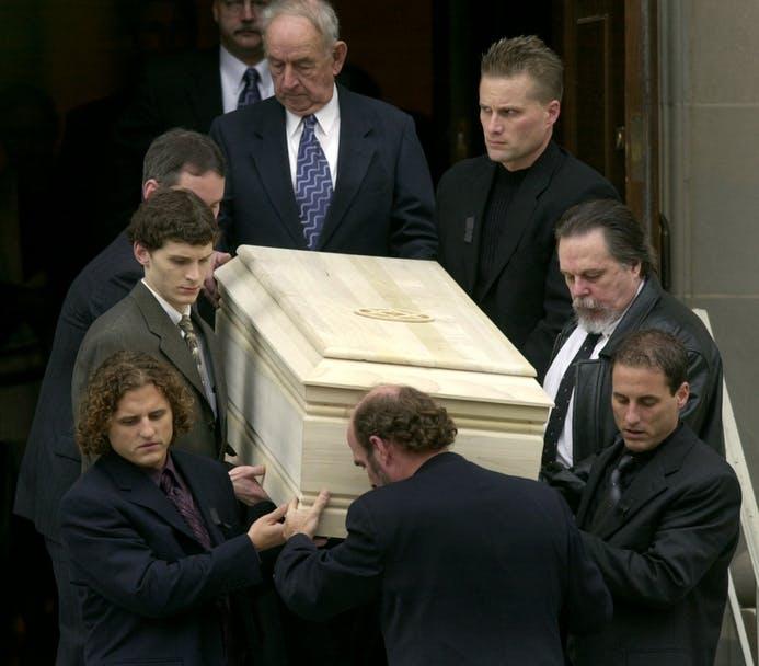 Pall bearers carry the casket of Sen. Paul Wellstone, D-Minn., including Wellstone's sons Mark, lower left, and David, lower right, from a private fun