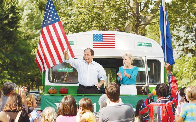 U.S. Sen. Paul Wellstone and his wife, Sheila, campaign from the back of Wellstone's well-known green bus. The beat-up bus was part of his three Senate campaigns. Wellstone Action Photo