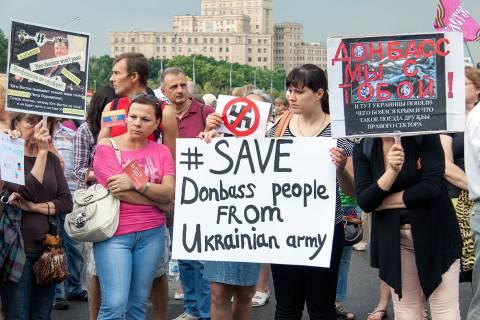 A group of people holding signs

Description automatically generated