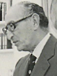 A person in a suit and tie
Description automatically generated with medium confidence