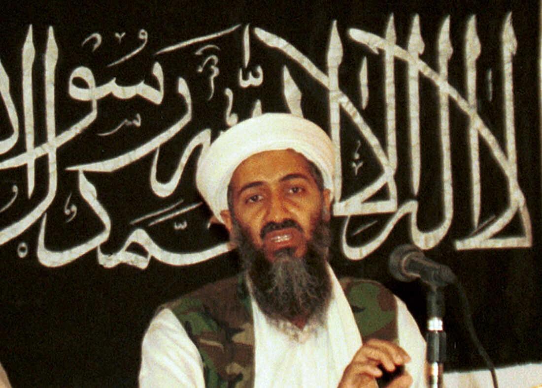 A person with a beard and a white turban with a microphone

Description automatically generated with low confidence
