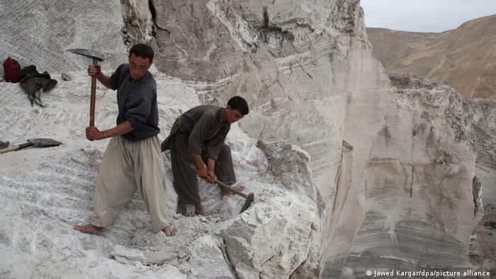 Afghan laborers collect salt from mines in Namak Aab district of Takhar province, Afghanistan.