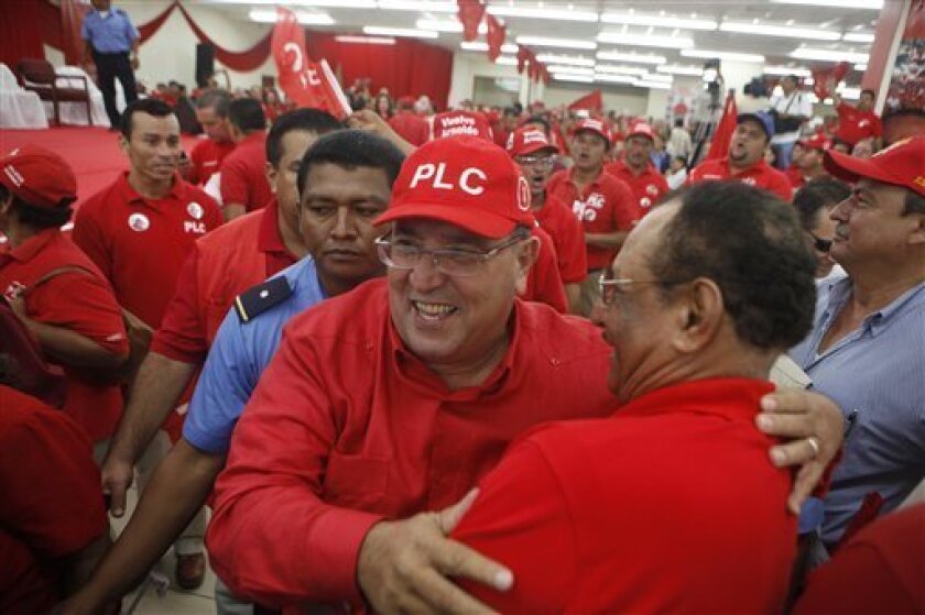 Nicaragua's former President Arnoldo Aleman, center, embraces a supporter at the Liberal Constitutionalism Party (PLC) convention in Managua, Sunday July 11, 2010. Aleman was chosen as PLC's presidential candidate for elections in Nov. 2011. Aleman was president from 1997 to 2002. (AP Photo/Esteban Felix)