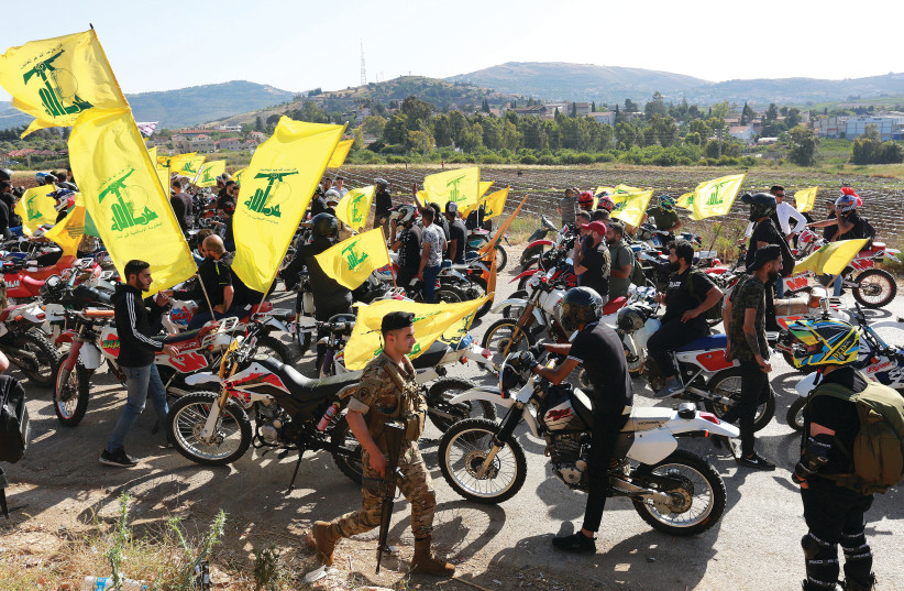 SUPPORTERS OF Hezbollah leader Hassan Nasrallah gather in a convoy of motorbikes marking ‘Resistance and Liberation Day’, near the Lebanese border with Israel, in May. (credit: AZIZ TAHER/REUTERS)