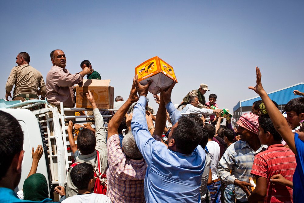 Syrian refugees, mostly Kurdish, recently arrived in the semi-autonomous region of Iraqi Kurdistan pictured at a reception and registration area near the town of Faysh Khabur. Aid was handed out at the reception area by the UN, Iraqi Kurdish authorities a