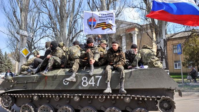A group of people sitting on a tank

Description automatically generated with medium confidence