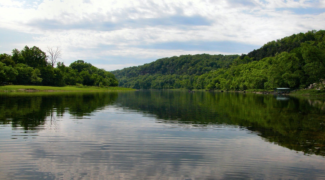 A lake surrounded by trees
Description automatically generated with medium confidence