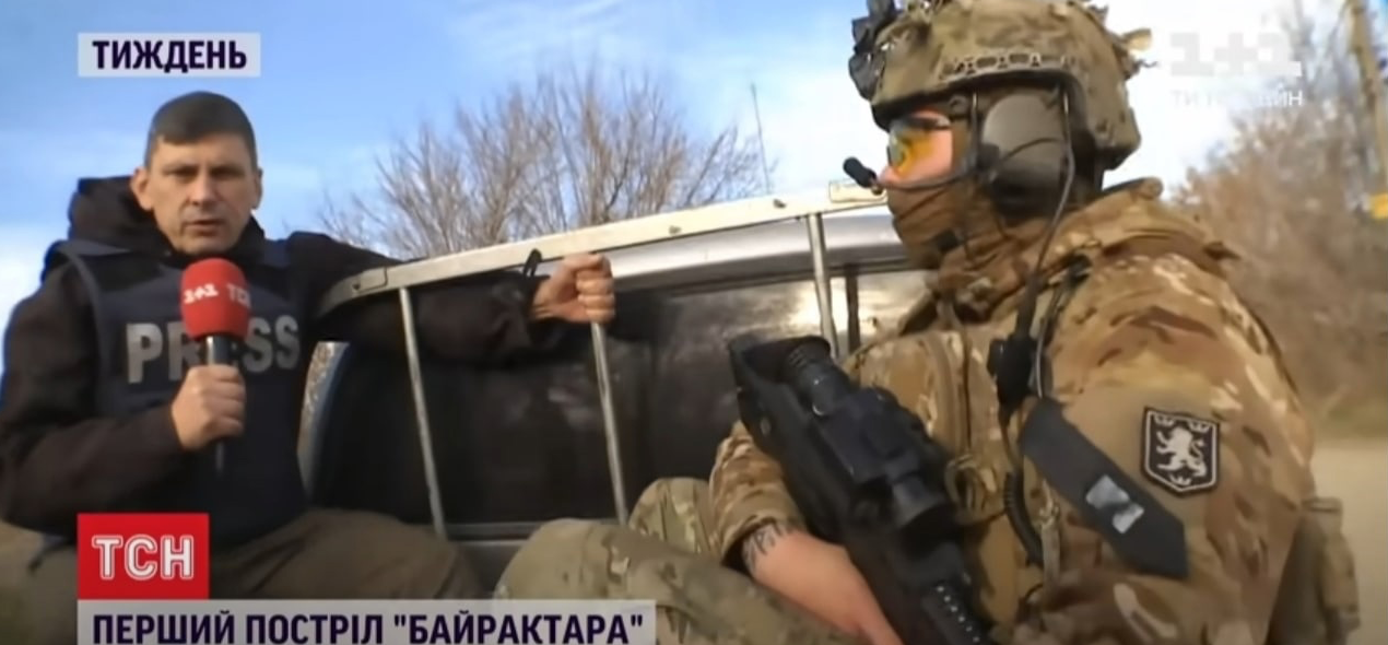 A person holding an object next to a person in a military uniform

Description automatically generated with low confidence