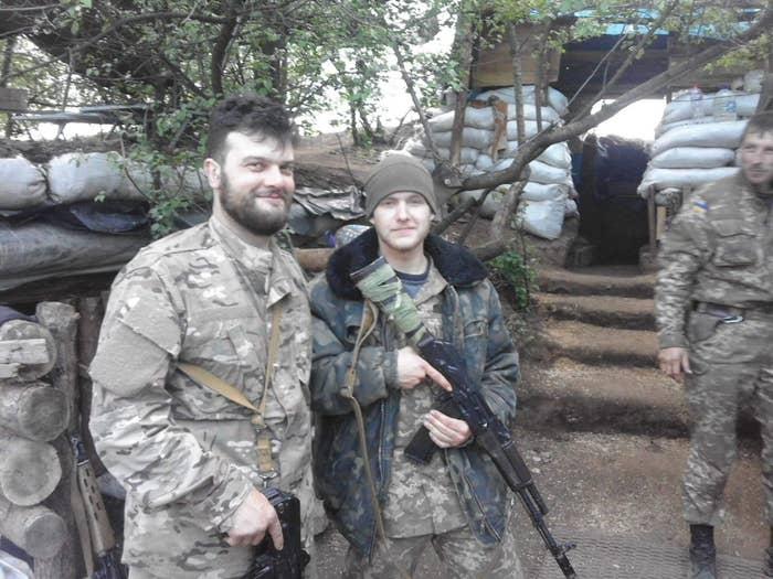 A person holding an object next to a person in military uniform

Description automatically generated with low confidence