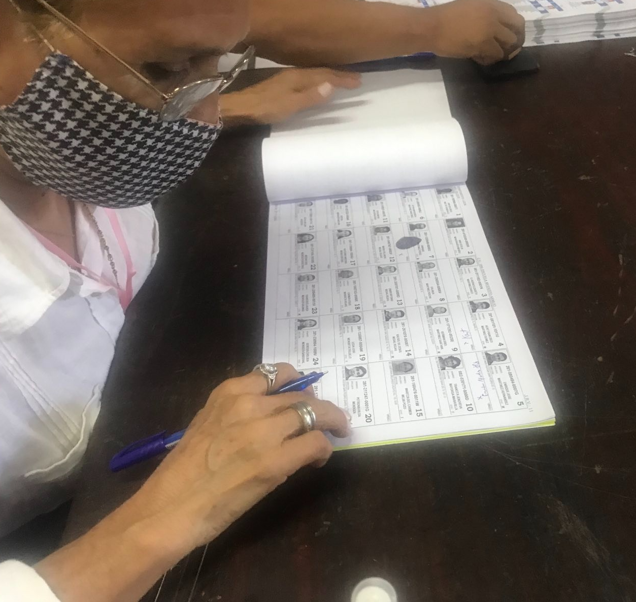 A person writing on a piece of paper
Description automatically generated with medium confidence