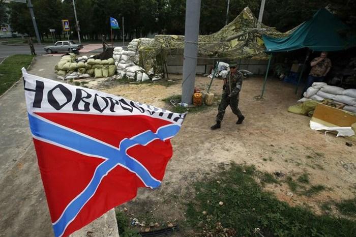 The flag of Novorossiya (New Russia) flies at a checkpoint manned by pro-Russian fighters (Reuters)