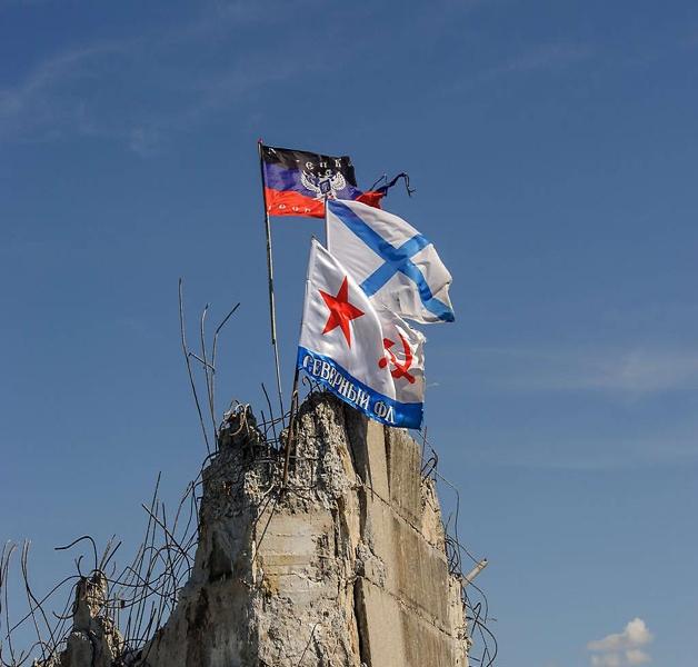 Three flags on top of the ruined obelisk