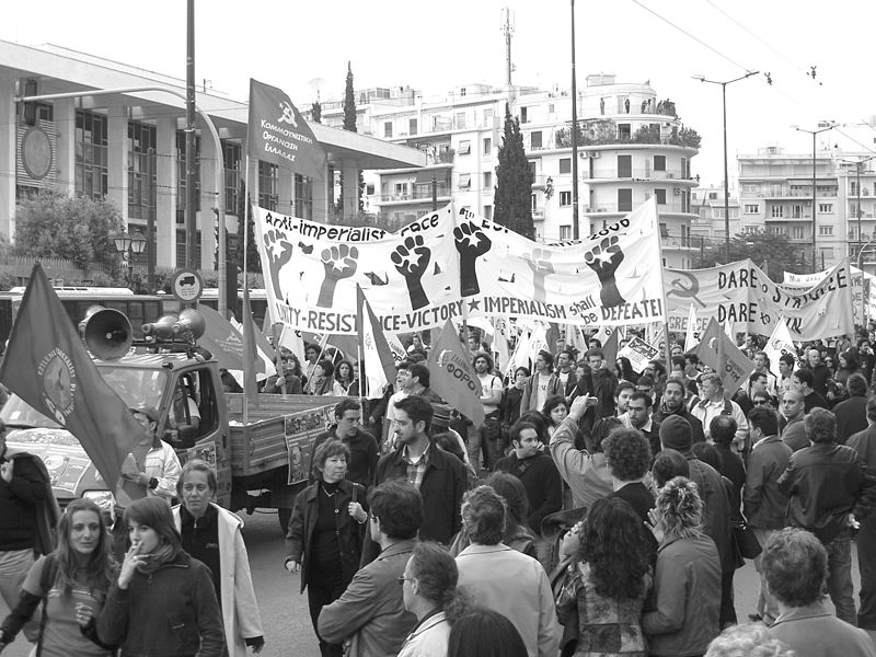 A crowd of people holding flags

Description automatically generated with low confidence