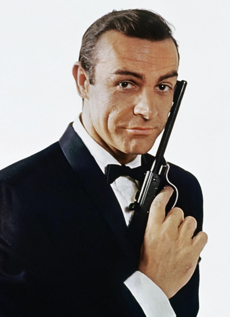 A person in a suit holding an object

Description automatically generated with medium confidence
